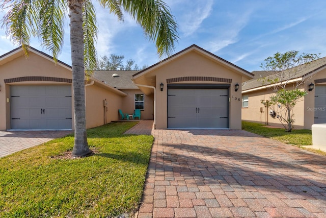 ranch-style home featuring a garage and a front yard