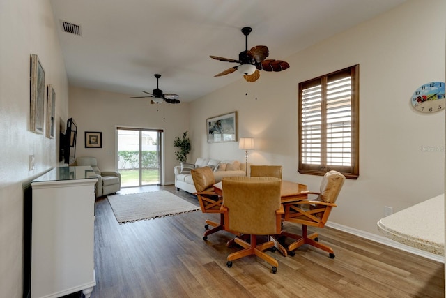 dining room with ceiling fan and light hardwood / wood-style flooring