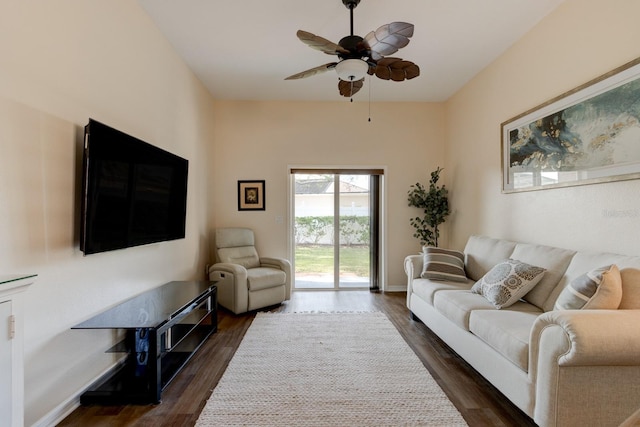 living room featuring dark hardwood / wood-style flooring and ceiling fan