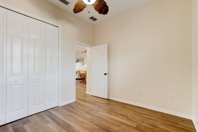 unfurnished bedroom featuring a closet, ceiling fan, and light hardwood / wood-style flooring