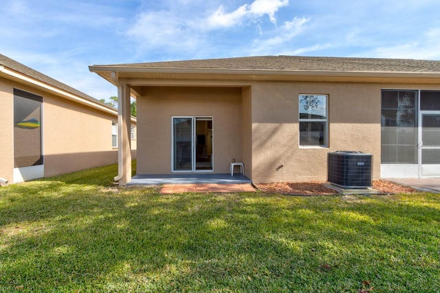 back of property with a patio, cooling unit, and a lawn