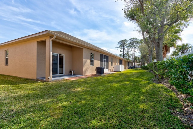 exterior space featuring a yard, a patio, and central air condition unit