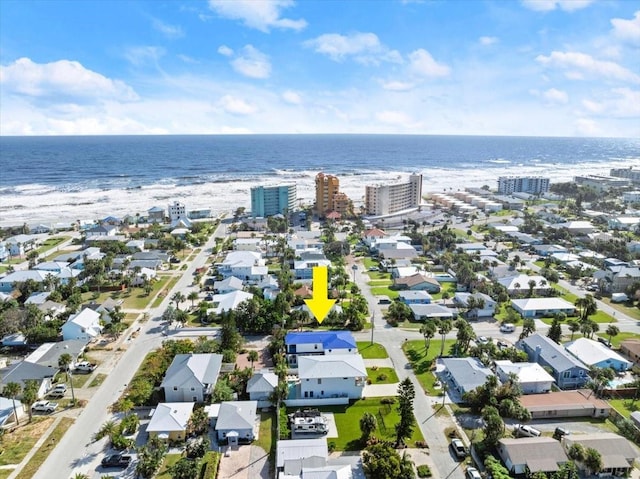 birds eye view of property with a water view and a view of the beach