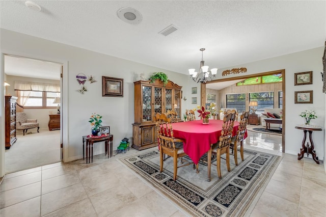 tiled dining area with a textured ceiling and a notable chandelier