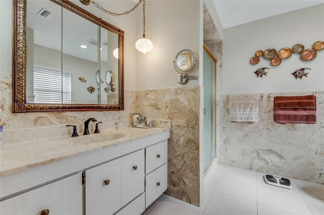 bathroom featuring tile walls, vanity, tile patterned floors, and an enclosed shower