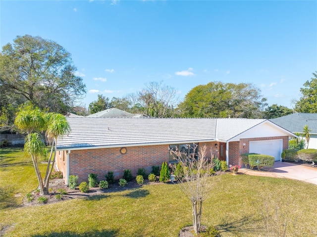 ranch-style house featuring a garage and a front lawn