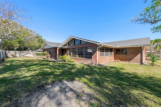 back of property featuring a lawn