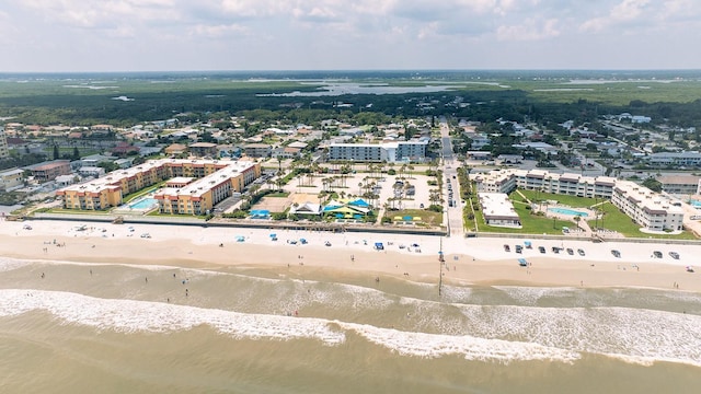 aerial view with a water view and a beach view