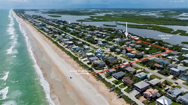 birds eye view of property featuring a water view and a view of the beach