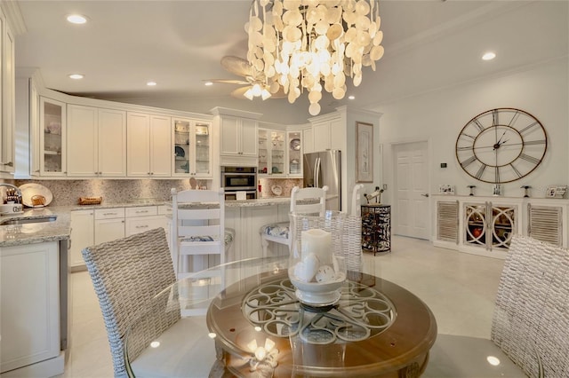 tiled dining area with sink and crown molding