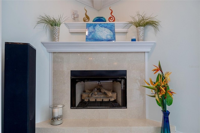 interior details featuring a tiled fireplace