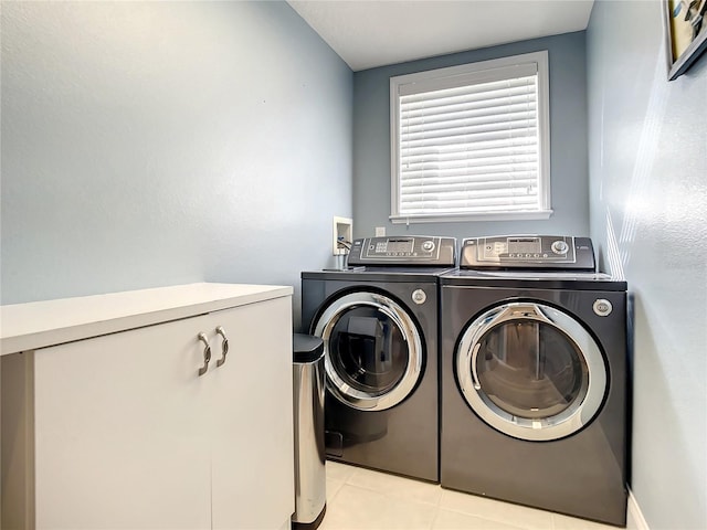 washroom with light tile patterned flooring and separate washer and dryer