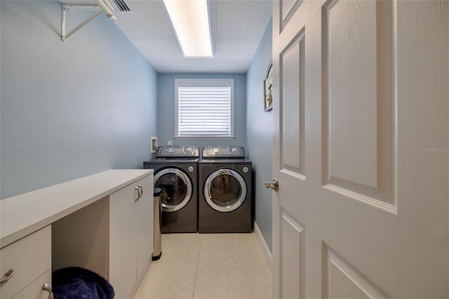 washroom with light tile patterned flooring and washing machine and clothes dryer