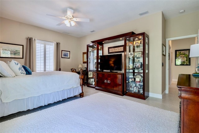 tiled bedroom featuring ceiling fan