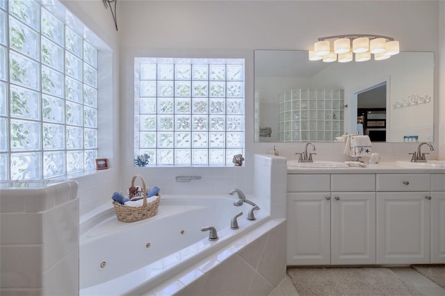 bathroom with vanity and tiled bath