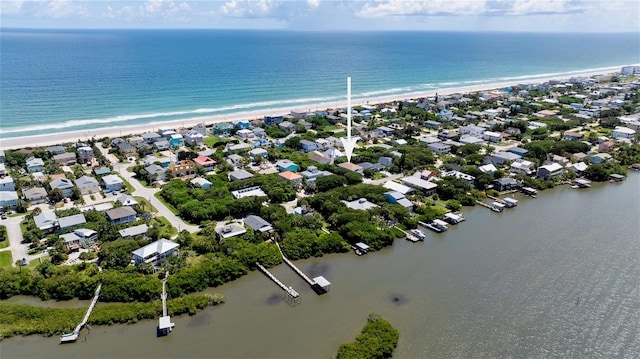 bird's eye view with a water view and a beach view