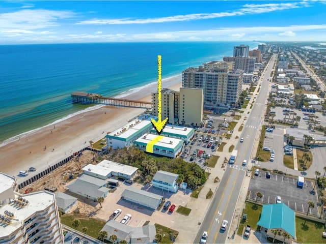 drone / aerial view featuring a beach view and a water view