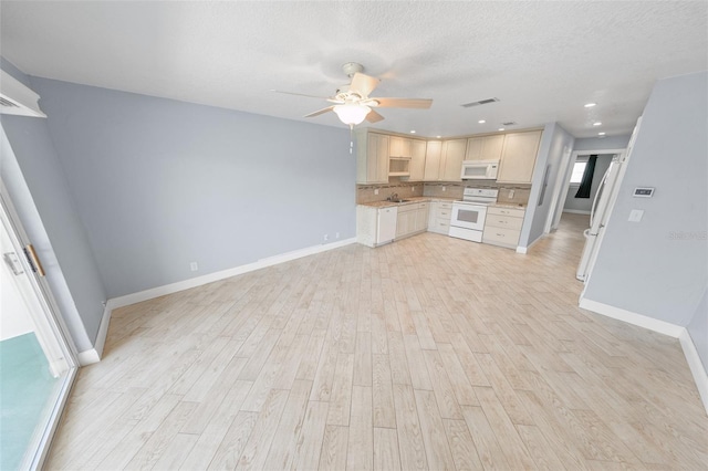 kitchen with sink, white appliances, ceiling fan, a textured ceiling, and light wood-type flooring