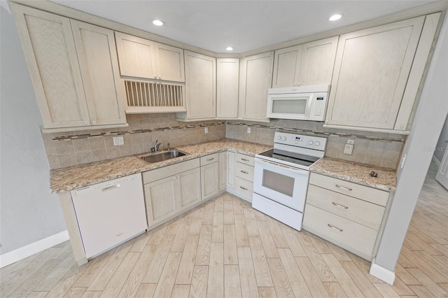 kitchen featuring sink, light wood-type flooring, decorative backsplash, light stone countertops, and white appliances