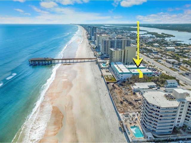 birds eye view of property with a water view and a view of the beach