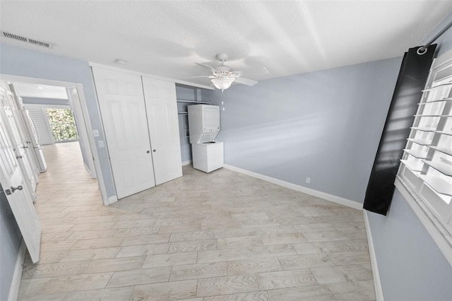 unfurnished bedroom with ceiling fan, a textured ceiling, a closet, and light hardwood / wood-style flooring