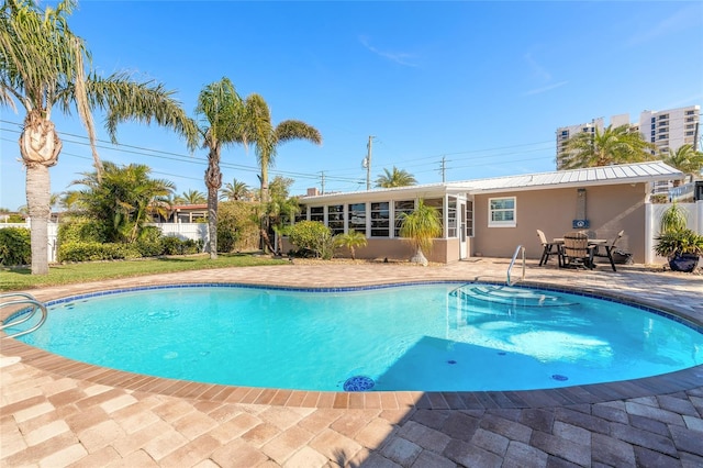 view of swimming pool with a patio