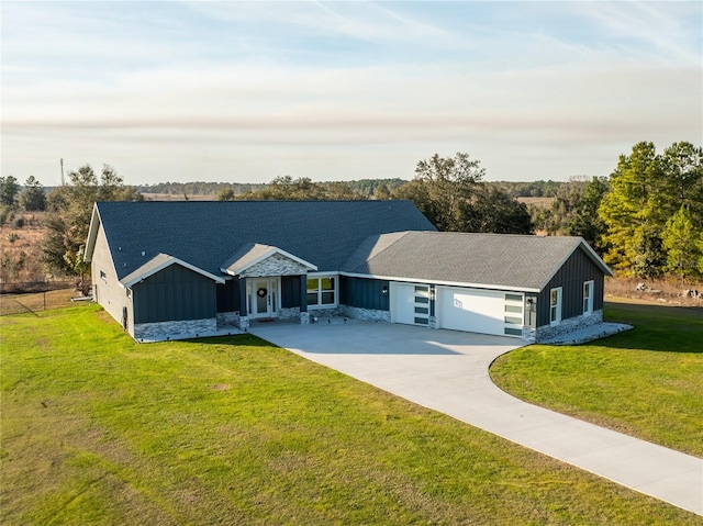 ranch-style home featuring a garage and a front lawn