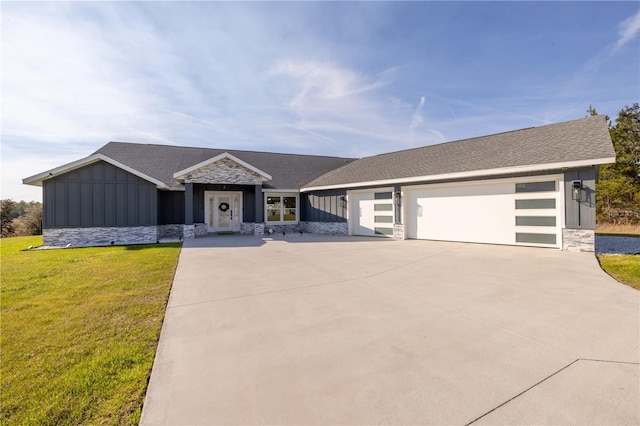 view of front of house featuring a garage and a front lawn