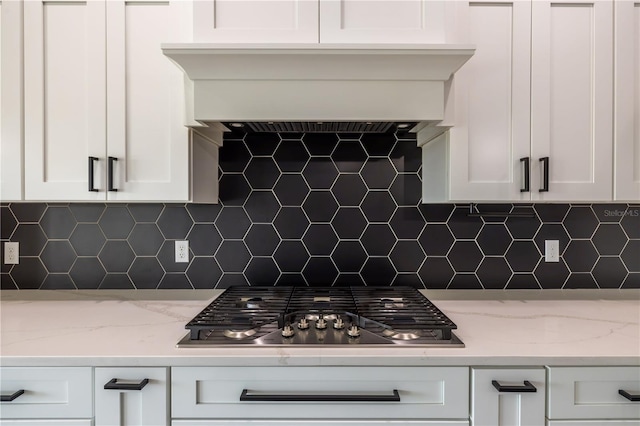 kitchen featuring white cabinetry, light stone countertops, and stainless steel gas cooktop