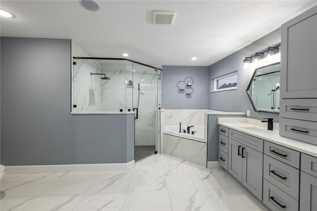 bathroom with vanity and shower with separate bathtub