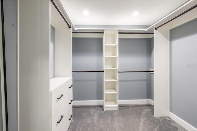 spacious closet featuring dark carpet