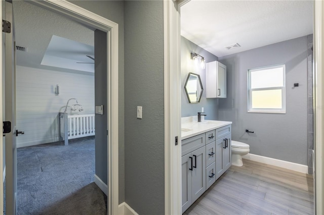 bathroom featuring hardwood / wood-style flooring, vanity, and toilet