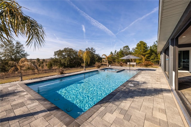 view of swimming pool with a jacuzzi and a patio area