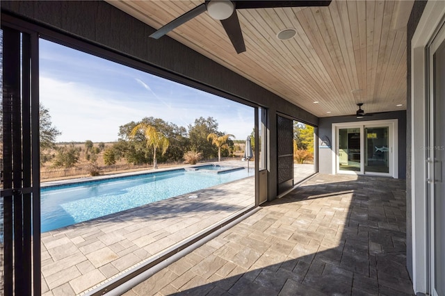 view of swimming pool featuring a patio area and ceiling fan