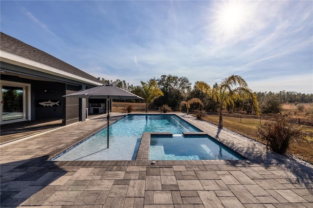 view of pool featuring a patio area and an in ground hot tub