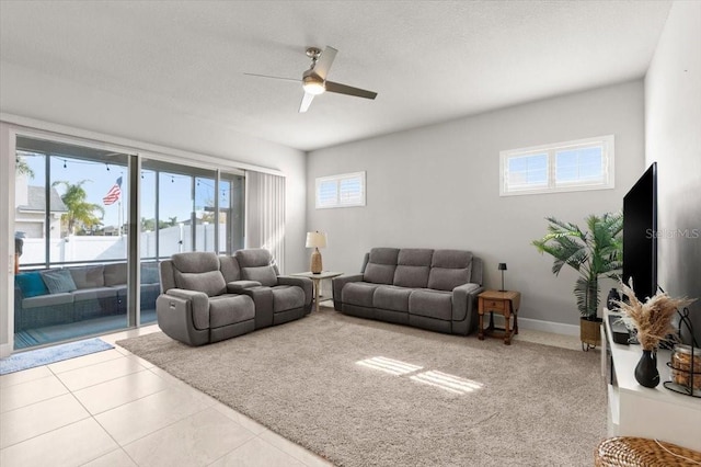 tiled living room featuring ceiling fan and a textured ceiling