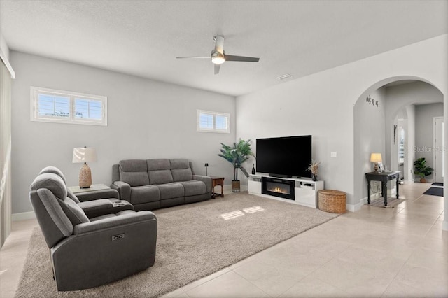 carpeted living room with ceiling fan