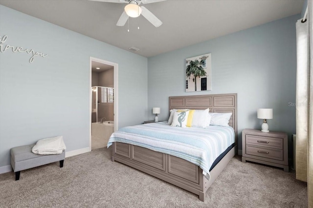 carpeted bedroom featuring ensuite bath and ceiling fan