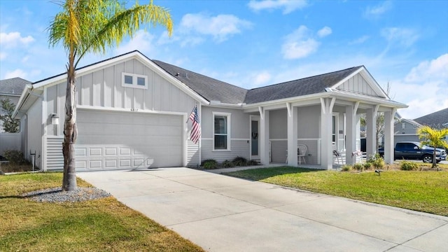 view of front of home with a garage and a front lawn