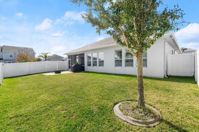 rear view of house with a yard and a patio area