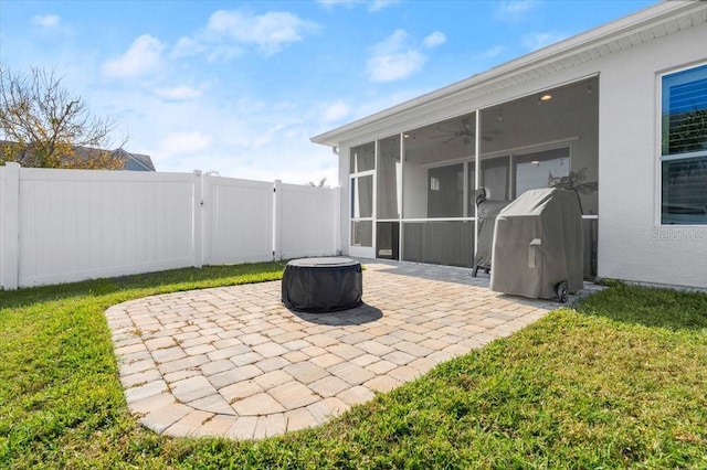 view of patio featuring ceiling fan, grilling area, and a sunroom