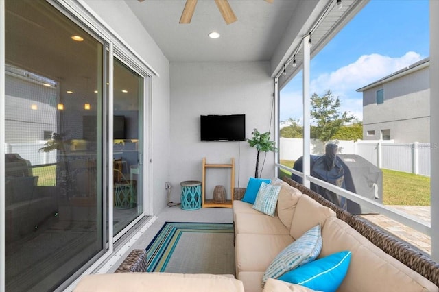 sunroom / solarium featuring ceiling fan