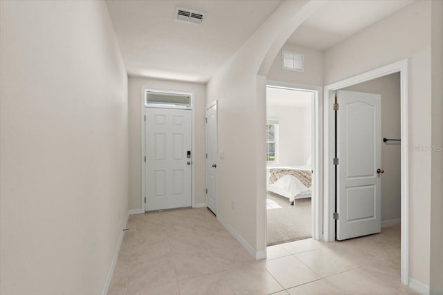 hall with light tile patterned floors