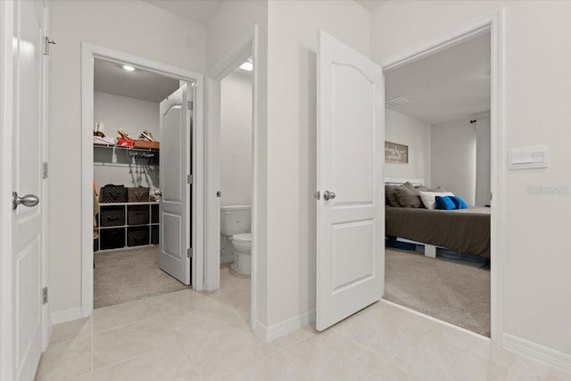 bathroom with tile patterned flooring and toilet