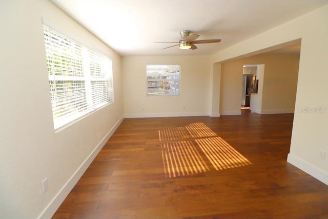 spare room featuring dark hardwood / wood-style floors and ceiling fan