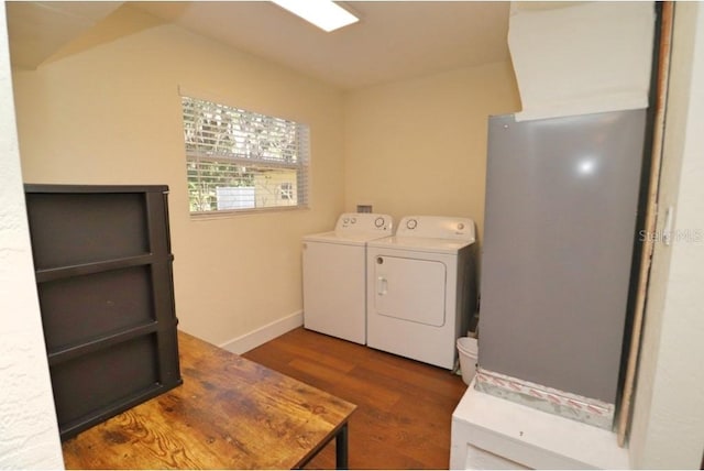 washroom featuring dark hardwood / wood-style floors and washer and clothes dryer