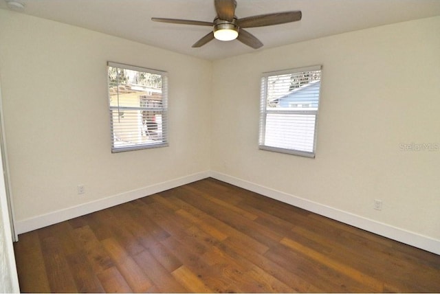 spare room featuring plenty of natural light, dark hardwood / wood-style floors, and ceiling fan