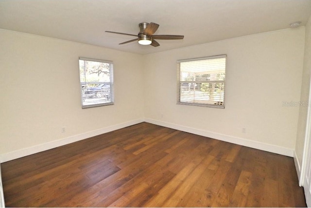 spare room featuring dark hardwood / wood-style floors and ceiling fan