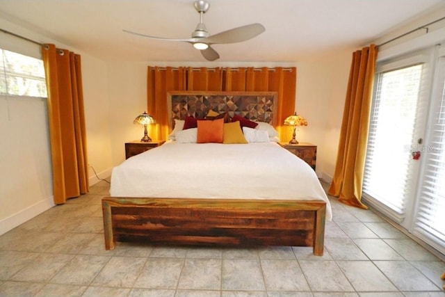 bedroom featuring ceiling fan, multiple windows, and access to outside