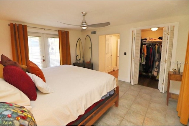 bedroom with a walk in closet, a closet, and ceiling fan